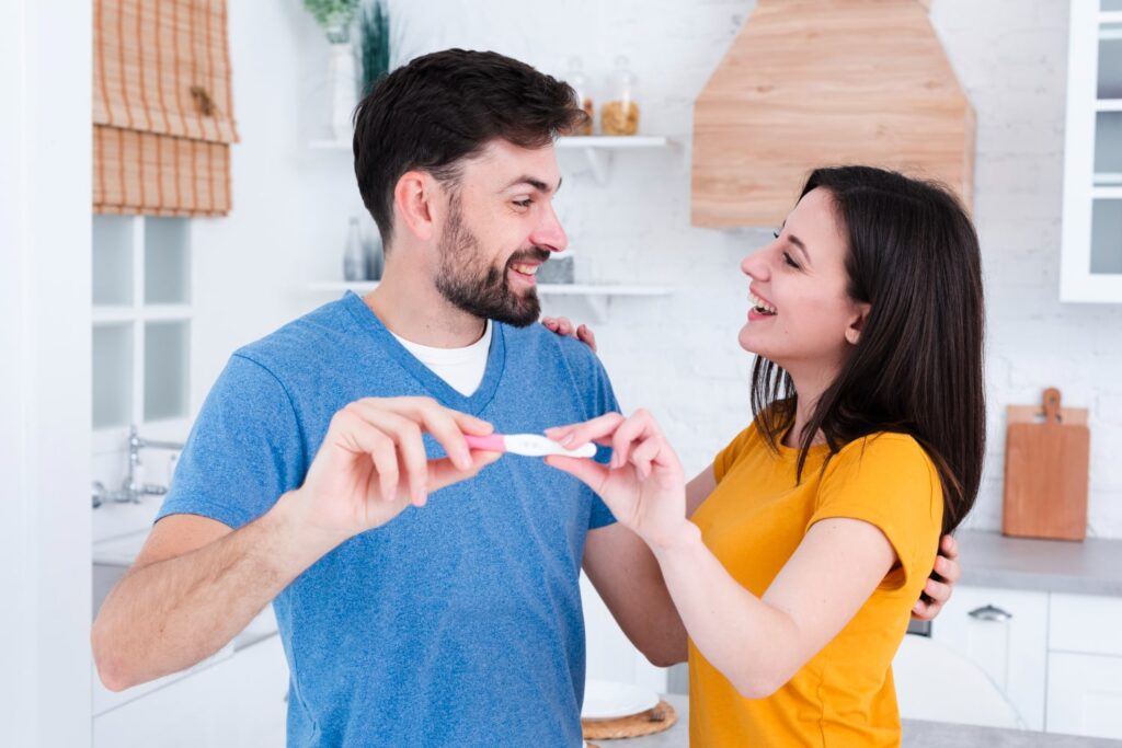 Couple holding a baby bootie, symbolizing hope and steps to boost chances of conceiving naturally