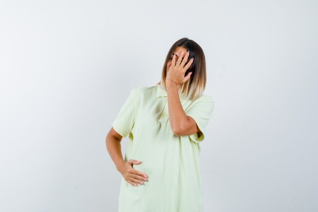 Miscarriage - A hopeful pregnant woman holding her baby bump with an ultrasound image in the background.